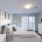 a bedroom with a bed and lamps