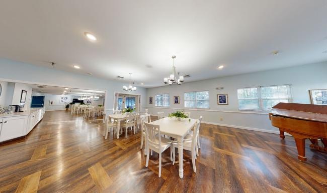 Settle into comfort at Serenity at West Columbia a large room with tables and chairs