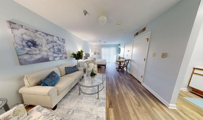 Settle into comfort at Serenity at West Columbia a living room with a white wall